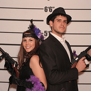 Anchorage Murder Mystery party guests pose for mugshots